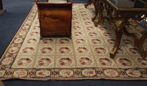 An Aubusson beige ground carpet, with all over repeat pattern of flowers in compartments, 14ft
