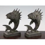 A pair of French Art Deco patinated bronze bookends, each modelled as fish, signed M. Bablot, each
