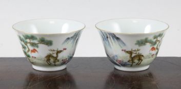 A pair of Chinese famille rose cups, each painted with a deer grasping lingzhi fungus by a waterfall