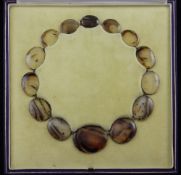 A 19th century gold and moss agate riviere necklace, set with fourteen graduated oval agate