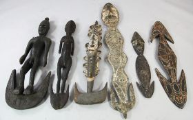 Papua New Guinea Sepik River, a collection of six carved wooden tribal food hooks, two with male and