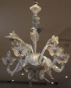 A Venetian style six branch chandelier, with twist S scroll arms, flower petal sconces with leaf and