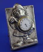 An Edwardian silver mounted rectangular watch holder frame embossed with the figure of a