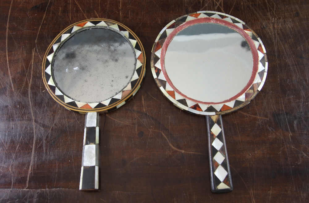 Two 19th century Ottoman circular hand mirrors, each with geometric mother of pearl, tortoiseshell