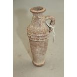 A Roman terracotta coiled container, c.1st / 2nd century AD, of slender form with ribbed shoulder