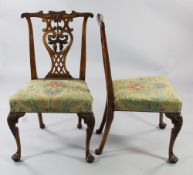 A pair of George III Chippendale style walnut dining chairs, with pierced shaped central splats,