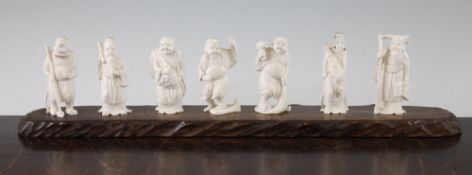A set of seven Japanese ivory figures of the Gods of Happiness and another ivory figure of an
