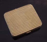A 1940's/1950's Cartier 14ct gold and sapphire set ribbed compact, of square form with rounded