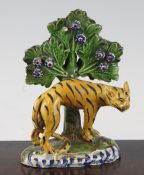 An early 19th century Staffordshire pearlware figure of an arched tiger, modelled on a