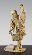 A Japanese Meiji period ivory okimono of a grape picker, Meiji period, signed to base, 17.2cm,