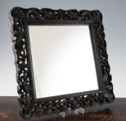 A Chinese rosewood framed mirror, late 19th / early 20th century, the frame intricately pierced