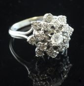An 18ct white gold and diamond cluster ring, of raised flowerhead design, size H.