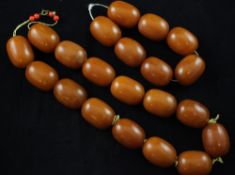 A single strand amber bead necklace and similar bracelet, of butterscotch colour, the necklace