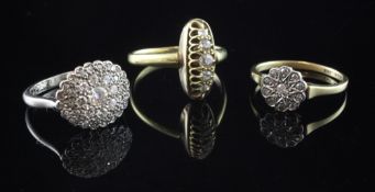 Two early 20th century 18ct gold and diamond cluster rings and one other gold and diamond ring