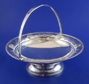 An Edwardian Arts & Crafts silver cake basket by Goldsmiths & Silversmiths Co Ltd, with pierced