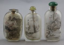 Three Chinese inside-painted glass snuff bottles, 20th century, each decorated with birds amid