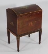 An Edwardian dome topped mahogany and floral painted canterbury, on tapered legs and spade feet, W.