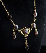 A Victorian style 18k gold and garnet drop pendant necklace, set with one round and seven oval cut