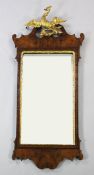 A mid 18th century fret cut walnut wall mirror, with gilt ho ho bird crest, 4ft x 1ft 9.5in.