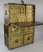 A 17th century Spanish walnut vargueno, with gilt metal and red velvet mounts, the fall front