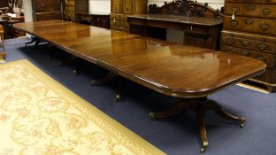 A large William IV and later mahogany five pillar extending dining table, with four extra leaves,