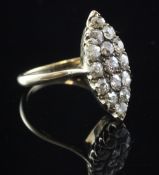 An early 20th century gold and diamond marquise shaped ring, set with fifteen old cut stones, size