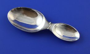 A 20th century Cartier sterling silver travelling double measure folding spoon, signed and