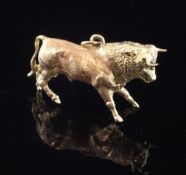 An 18ct gold bracelet charm, modelled as a bull, 9 grams, 1.25in.