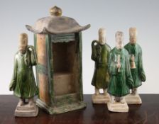 Four pottery tomb figures and a similar model of a shrine, Tang dynasty, two of the figures modelled