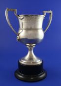 A George III Scottish silver two handled trophy cup by P. Cunningham & Sons, with engraved foliate