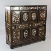 An early 20th century Chinese hardwood cabinet, inlaid with mother of pearl depicting traditional