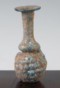 A Roman turquoise glass 'grape' flask, Syria 1st / 2nd century AD, with bottle neck and mineral