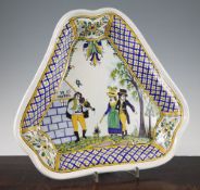 A French faience pottery dish, 19th century, decorated in underglaze blue and yellow and green