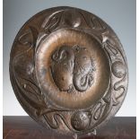 A John Pearson Arts & Crafts circular copper charger, centred with two stylised fish, the wide