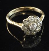 A 1940's 18ct gold and diamond cluster ring, of flowerhead design, set with nine old cut diamonds,