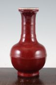 A Chinese sang de boeuf glazed bottle vase, 18th / 19th century, with rib moulded neck and