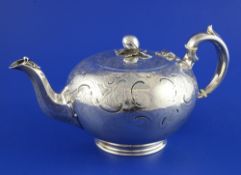 A Victorian silver teapot by The Barnards, of spherical form, with engraved foliate scroll