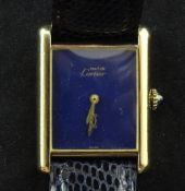 A lady's silver gilt Must de Cartier manual wind wrist watch, with rectangular blind lapis lazuli