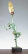 A French Art Deco green patinated figural table lamp, modelled as a female dancer standing on one