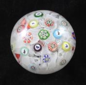 A mid 19th century Baccarat spaced millefiori paperweight, c.1848, inset with coloured canes