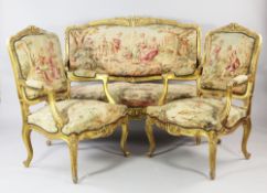 A Louis XV style floral carved three piece suite, comprising a settee and a pair of armchairs, all