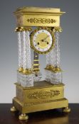 A 19th century French ormolu mounted cut glass portico clock, of traditional form with enamelled