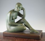 A French Art Deco painted terracotta model of a seated female nude, on rectangular base, signed