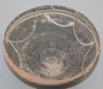 A Greek blackware bowl, c.2nd century BC, of curving conical form, the interior with white