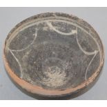 A Greek blackware bowl, c.2nd century BC, of curving conical form, the interior with white