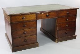 A Victorian mahogany pedestal desk, fitted with an arrangement of nine drawers opposing dummy