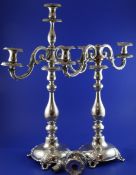 A pair of Polish? candlesticks, with turned knopped stems and engraved with Greek key bands, on