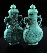 A pair of Chinese stained turquoise vases and covers, each of flattened baluster form with bands