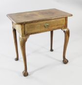 A George I featherbanded walnut side table, with single frieze drawer, on shell carved cabriole legs