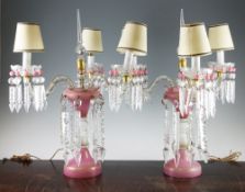 A pair of pink and white gilt decorated glass table lustres, later converted to candelabra with